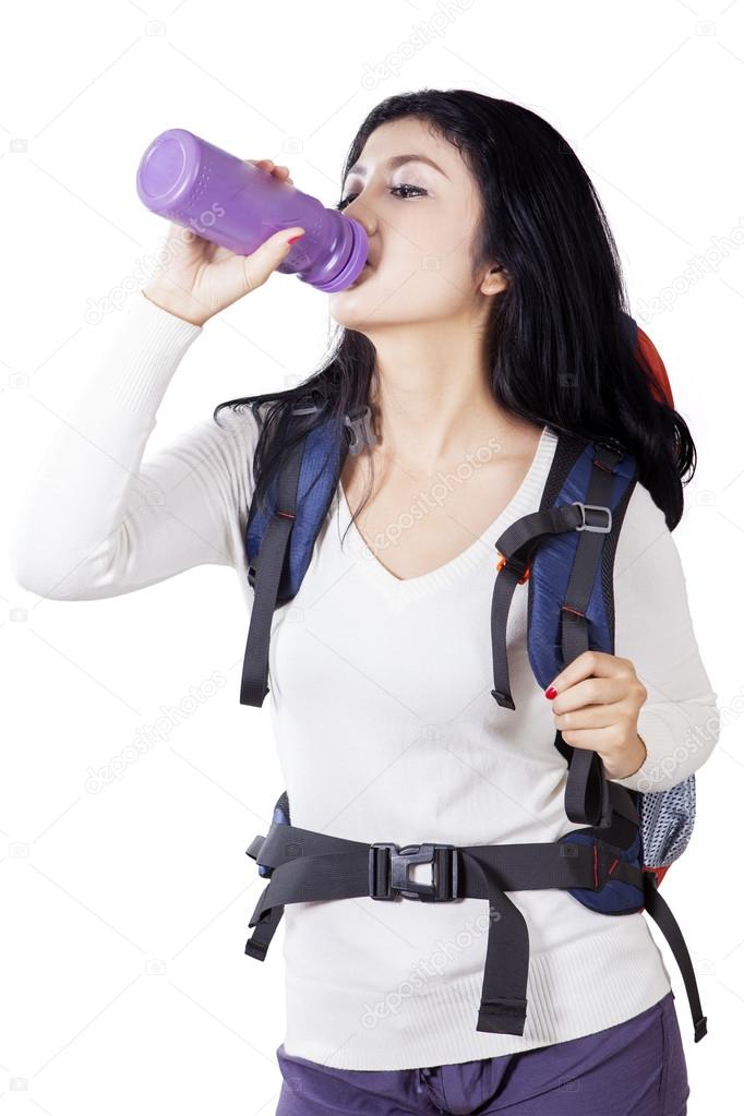 Beautiful hiker drinks fresh water