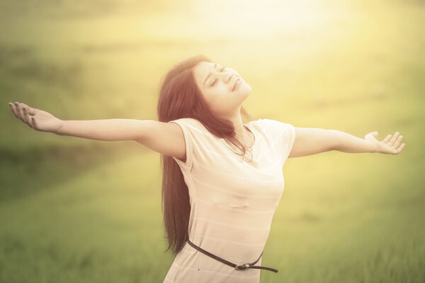 Lovely woman breathe fresh air at field