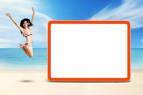 Lovely woman leaps at coast near the board — Stock Photo, Image