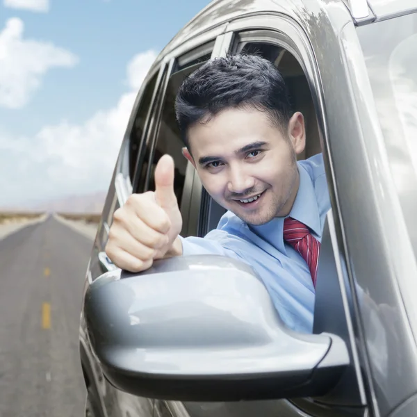 Happy businessman showing thumb up in car — Stock Photo, Image