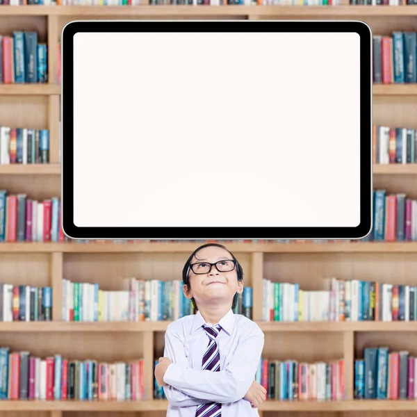 Smart little student looking up at whiteboard — Stock Photo, Image