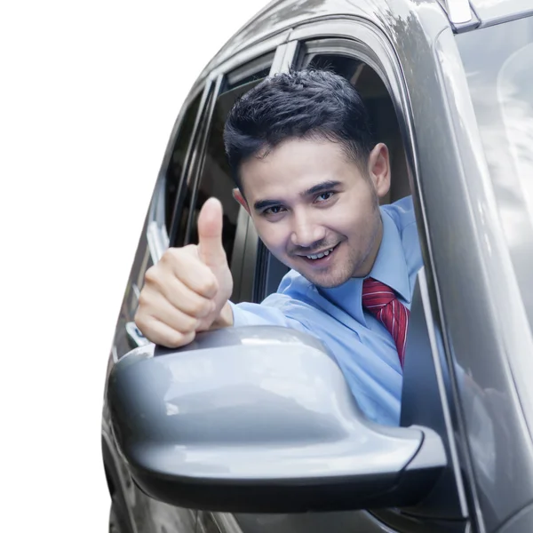 Successful man showing thumb up in car — Stock Photo, Image