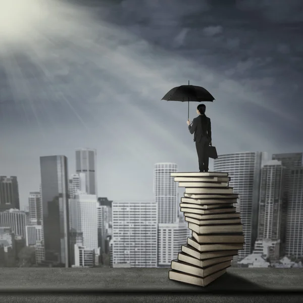 Woman standing on a pile of books — Stock Photo, Image