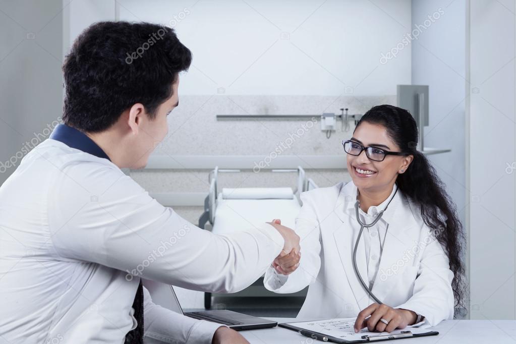Male patient shaking hands with doctor