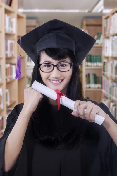 Bachelor with graduation gown and a diploma — Stock Photo, Image