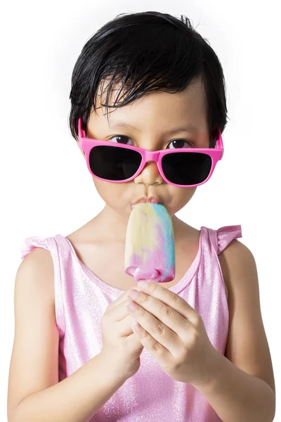 Child eats cold ice cream in studio — Stock Photo, Image