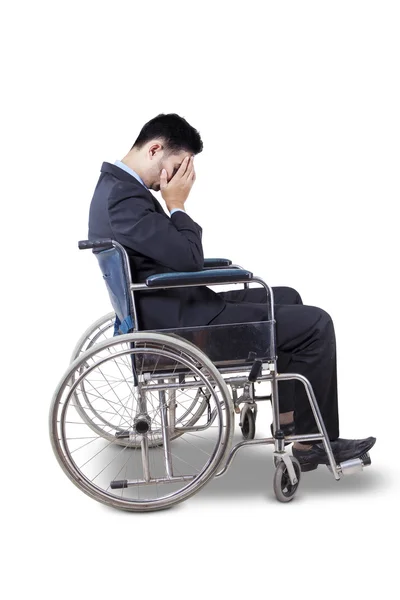 Sad entrepreneur sitting in wheelchair — Stock Photo, Image