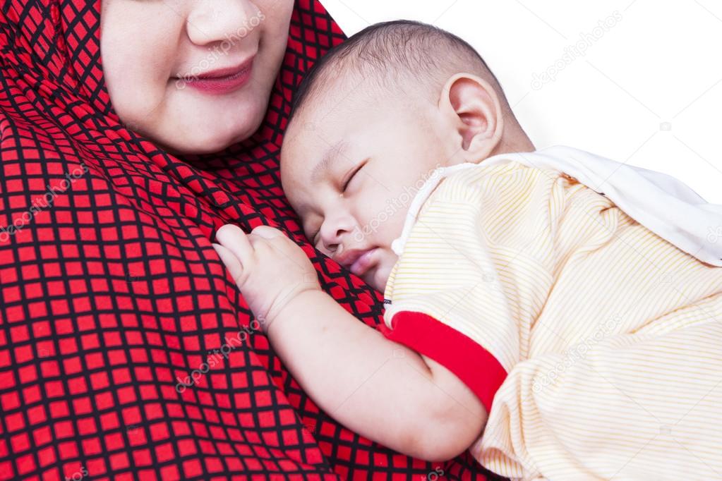 Cute baby sleeping on mother's chest Stock Photo by ©realinemedia 75254381