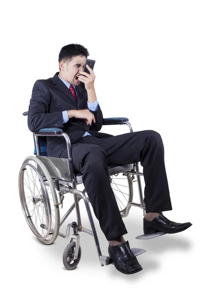 Mad businessman on wheelchair — Stock Photo, Image