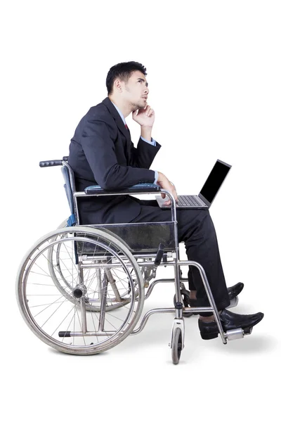 Thoughtful disabled businessman in studio — ストック写真