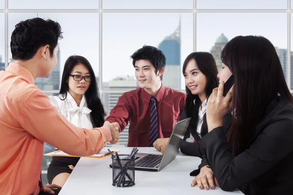 Two managers shaking hands in a meeting — 图库照片