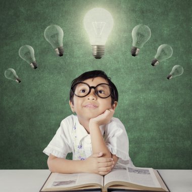 Little girl looking up bright lamp