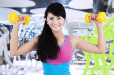 Slim woman workout with dumbbells