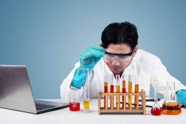 Serious scientist makes experiment in lab