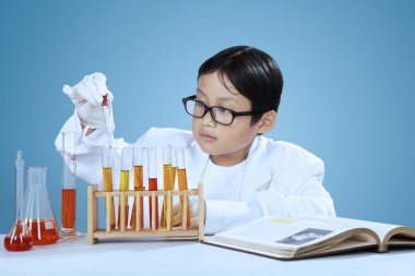 Scientist using pipette for dropping chemical
