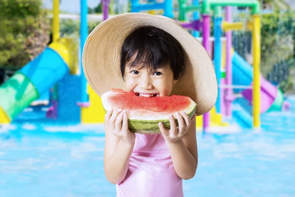 Criança come melancia na piscina — Fotografia de Stock