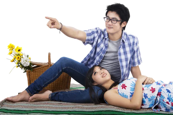 Couple sitting on mat and look at something — Stockfoto