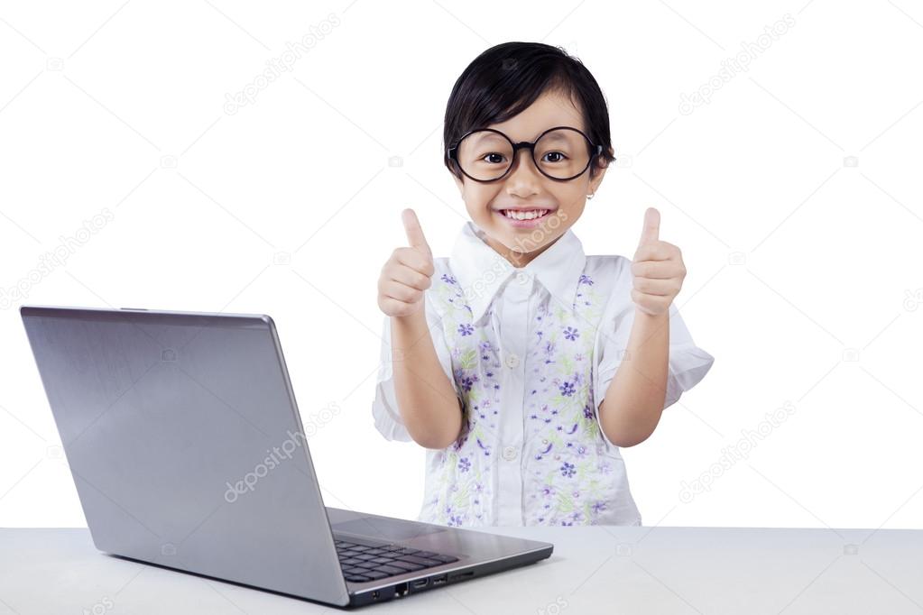 Modern little student with laptop and OK sign