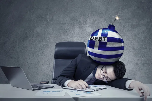 Employee with bomb of debt and Greek flag — Stockfoto