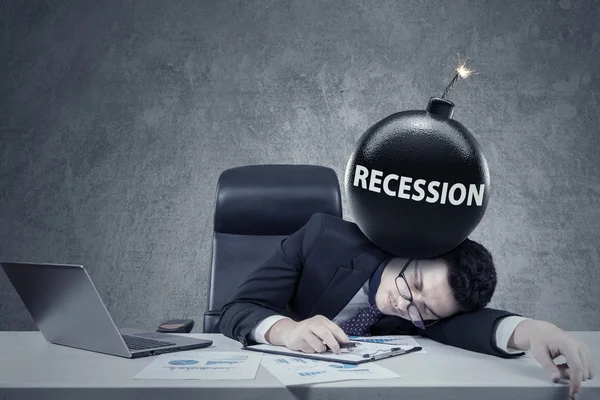 Worker with a bomb of financial recession — Stockfoto