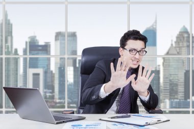Afraid businessperon working at workplace