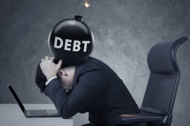 Bomb of business debt on businessman head