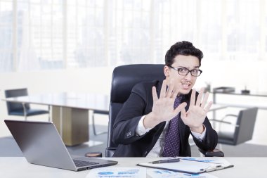 Businessman with scared expression in the office