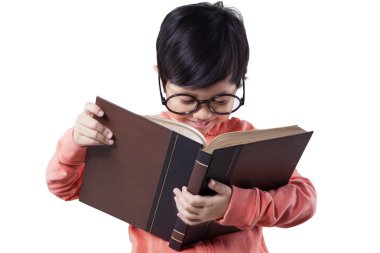 Female kindergarten student reads literature