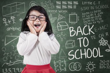 Funny little girl in classroom