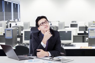 Pensive manager thinking a plan in office