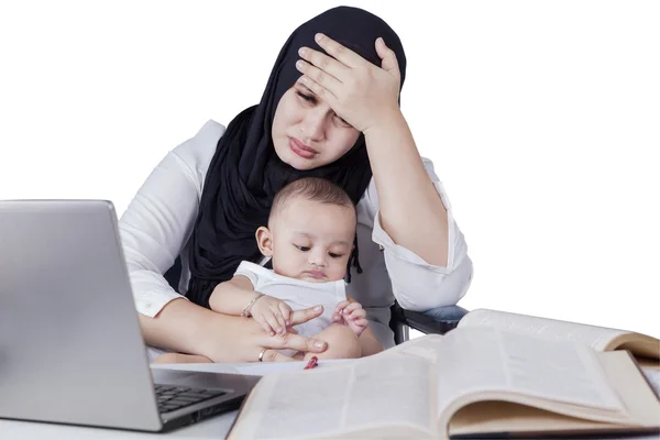 Frustrated mother working with baby — Stok fotoğraf