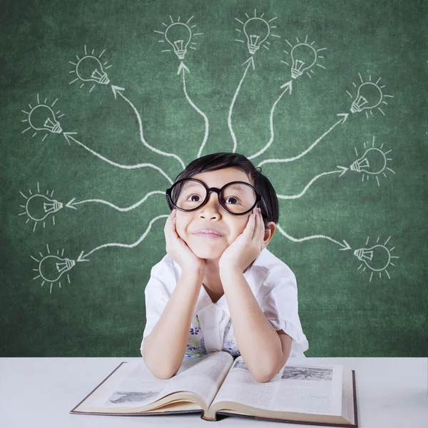 Thoughtful little girl with lamps branching — Stock Photo, Image