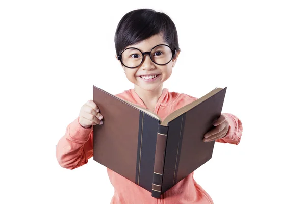 Cute child reading book in studio — Stock fotografie