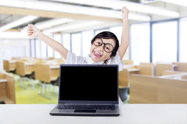 Cute little girl with laptop celebrate her success — Stock Photo, Image