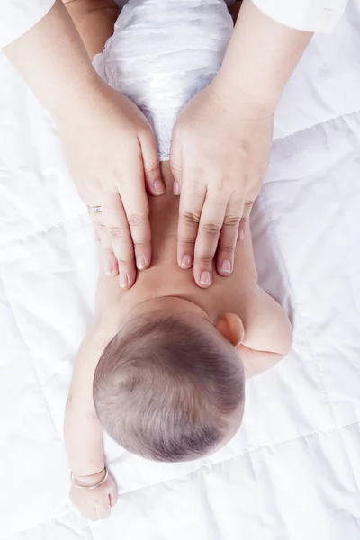 Mother massaging 4 months infant — ストック写真