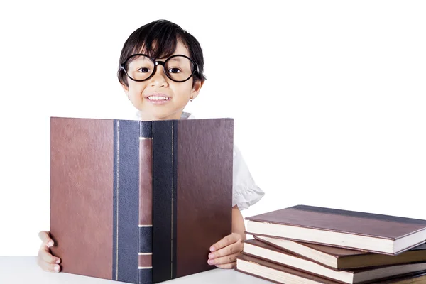 Clever schoolgirl reading books isolated ロイヤリティフリーのストック写真