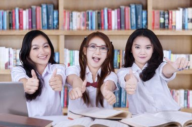 Group of lovely students with thumbs up
