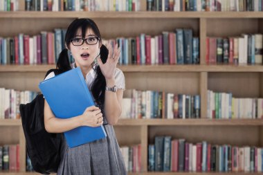 Shocked female student at library