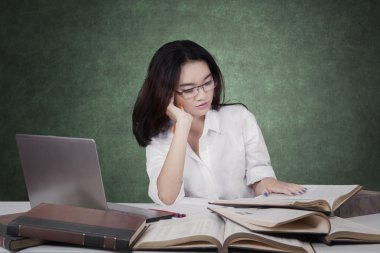 Pretty high school student studying on desk
