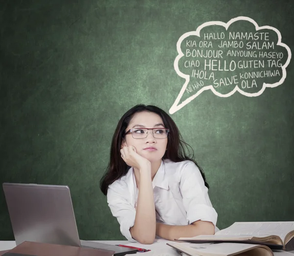 Lovely student with speech bubble of multi language — Stock fotografie
