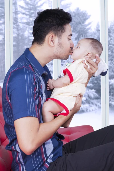 Cute baby kissed by his dad at home — 图库照片