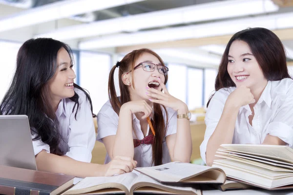 Three students back to school and talking in class — Stok fotoğraf