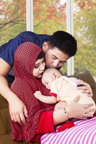 Happy muslim parents kiss their child — Stock Photo, Image