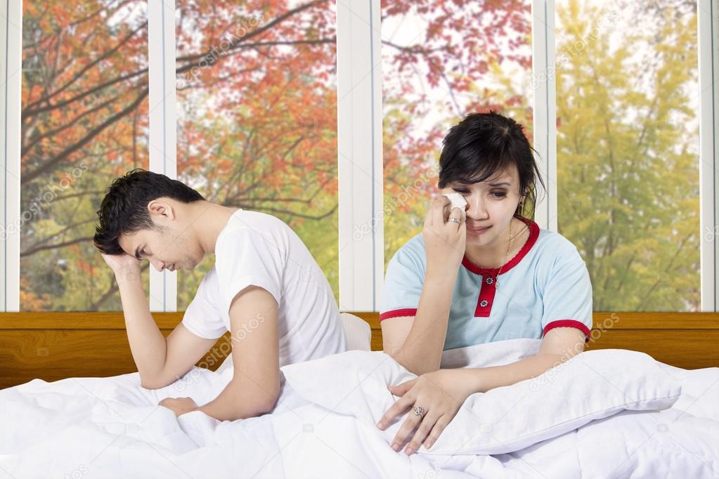 Asian couple after quarreling in bedroom