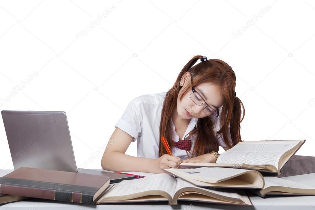 Sweet Student With Glasses Studying On Desk Stock Photo