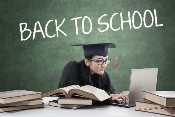 College student with graduation gown studying — Stock Photo, Image