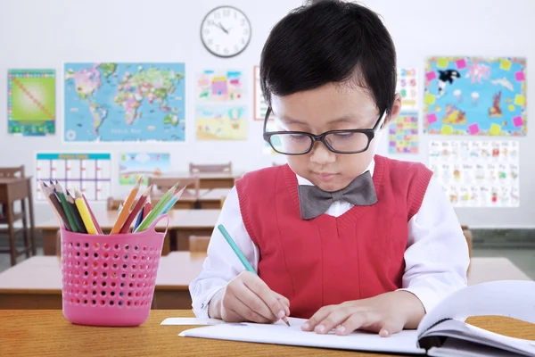 Elementary school student drawing on the paper — Stockfoto