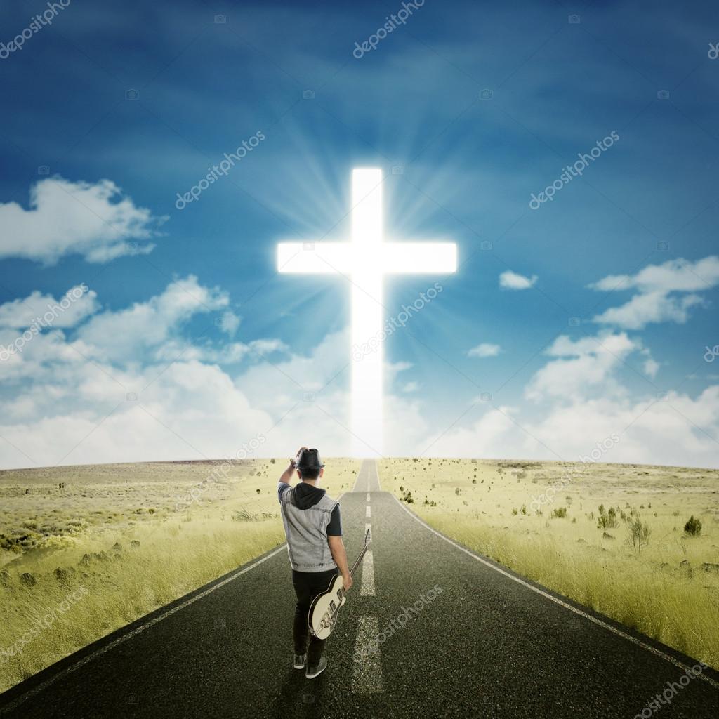 Singer with guitar walks to the cross — Stock Photo © realinemedia