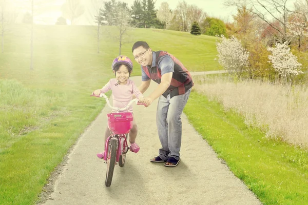 Papá entrena a su hija para montar en bicicleta —  Fotos de Stock