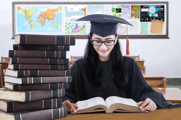 Student studeert in de klasse terwijl het dragen van mortarboard — Stockfoto